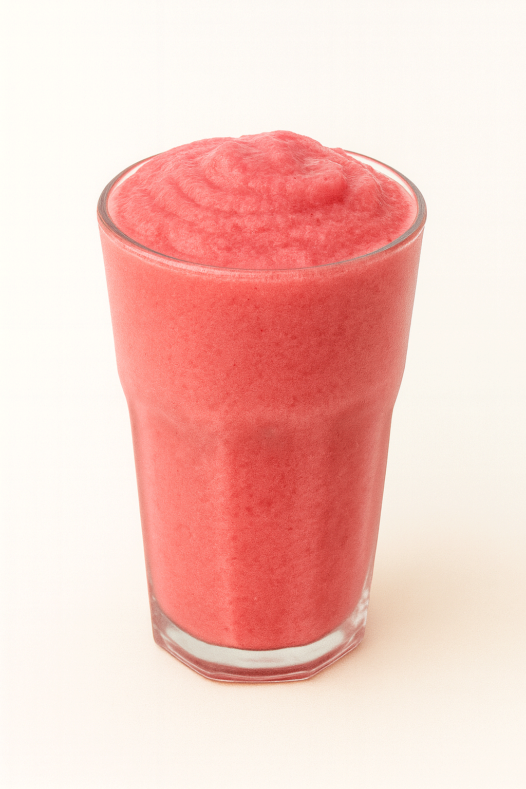 Strawberry smoothie in a clear glass, vibrant and refreshing